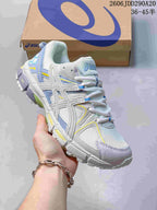 Angled side view of the white and blue ASICS sneaker showing the layered upper and treaded outsole.