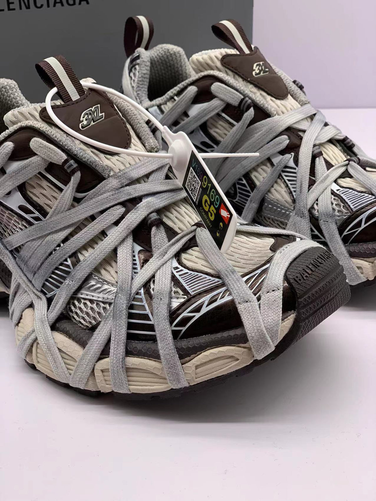 Close-up of the sneaker fronts, tongue details, layered laces, and contrasting brown and cream panels.