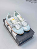 Pair of white and pale blue adidas JOG 2.0 sneakers with ribbon-style laces and gum-colored soles