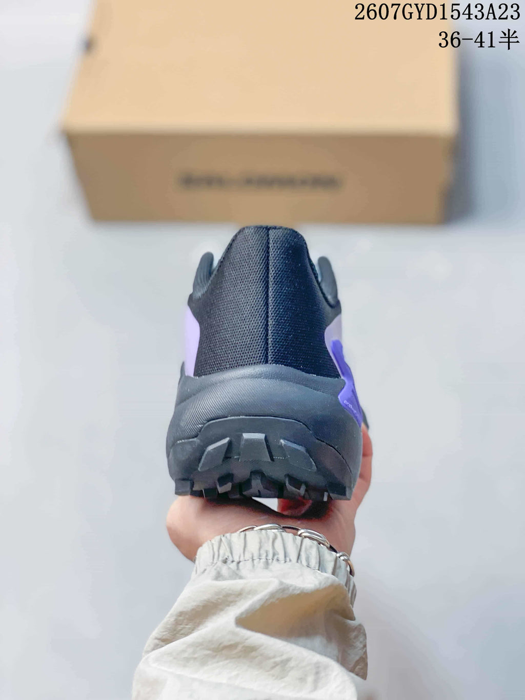Rear view of a Salomon Genesis shoe showing the padded heel collar and rugged outsole.
