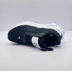 Top view of one sneaker displaying the tongue branding, laces, and textured upper.
