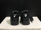 Rear view of the black sneaker pair showing contrasting white heel graphics and padded heel panels.