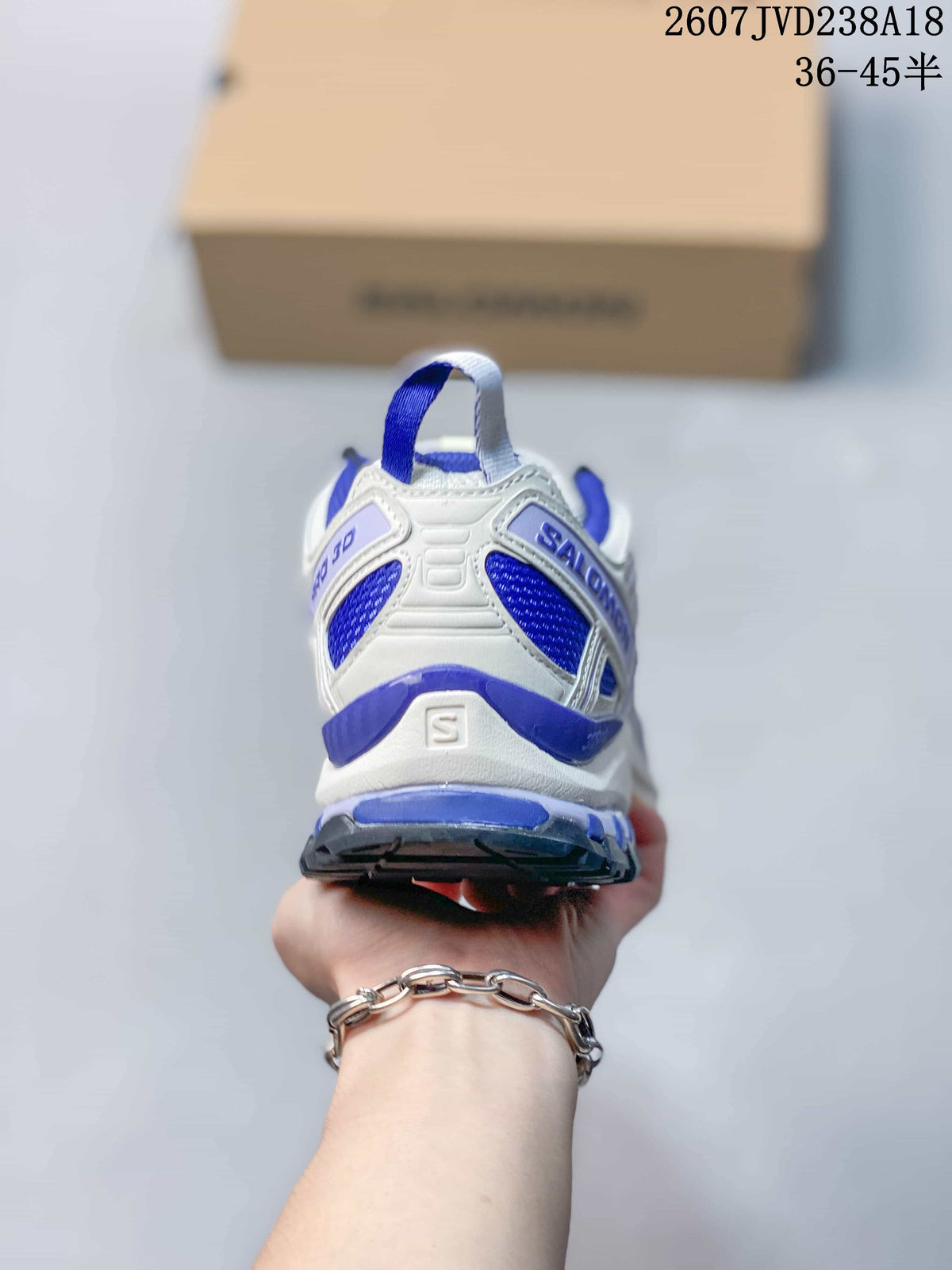 Rear view of the white and blue Salomon XA Pro 3D V9 shoe showing the heel structure and pull tab.