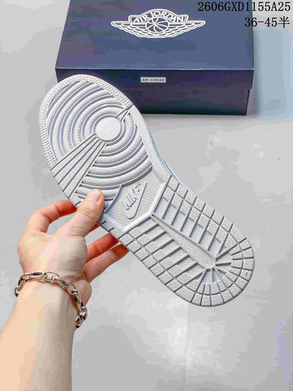 Close-up of the textured outsole and tread pattern of a white Jordan sneaker.