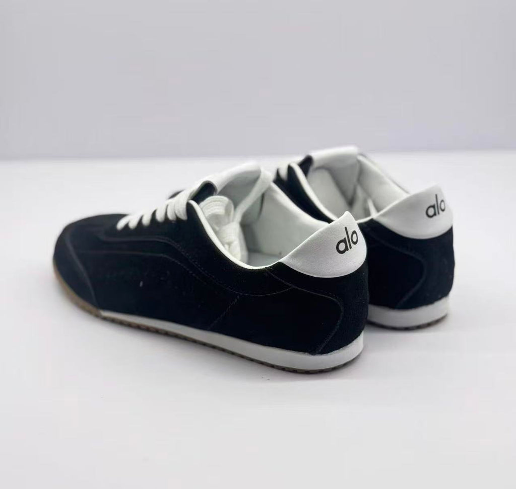 Rear view of the pair with Alo branding on the white heel panels.
