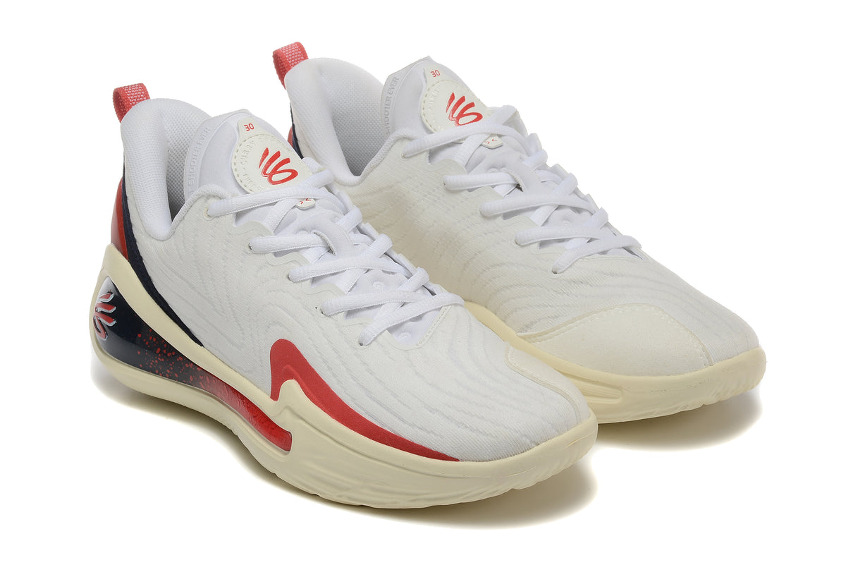 Three-quarter view of the pair of white basketball shoes with red and navy details