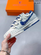 Side view showing the blue Swoosh, white midsole, blue outsole and patterned upper.