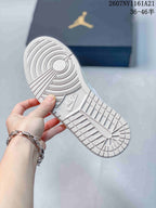 Close-up of the white rubber outsole showing concentric circular traction grooves, textured panels and a visible Nike mark.