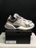 Side view of the sneaker positioned on a black box with a visible size label.
