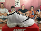 Side view of a white Nike The Glove basketball shoe with a sculpted sole
