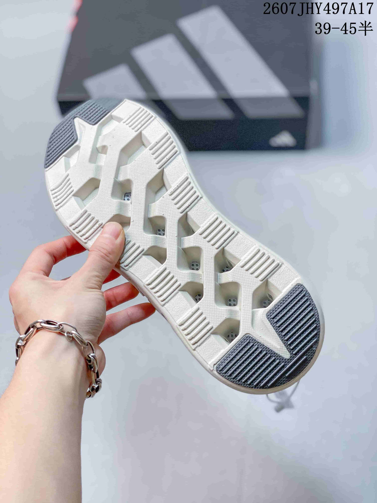 Underside view of the sneaker showing the segmented white outsole and dark contrasting traction sections.