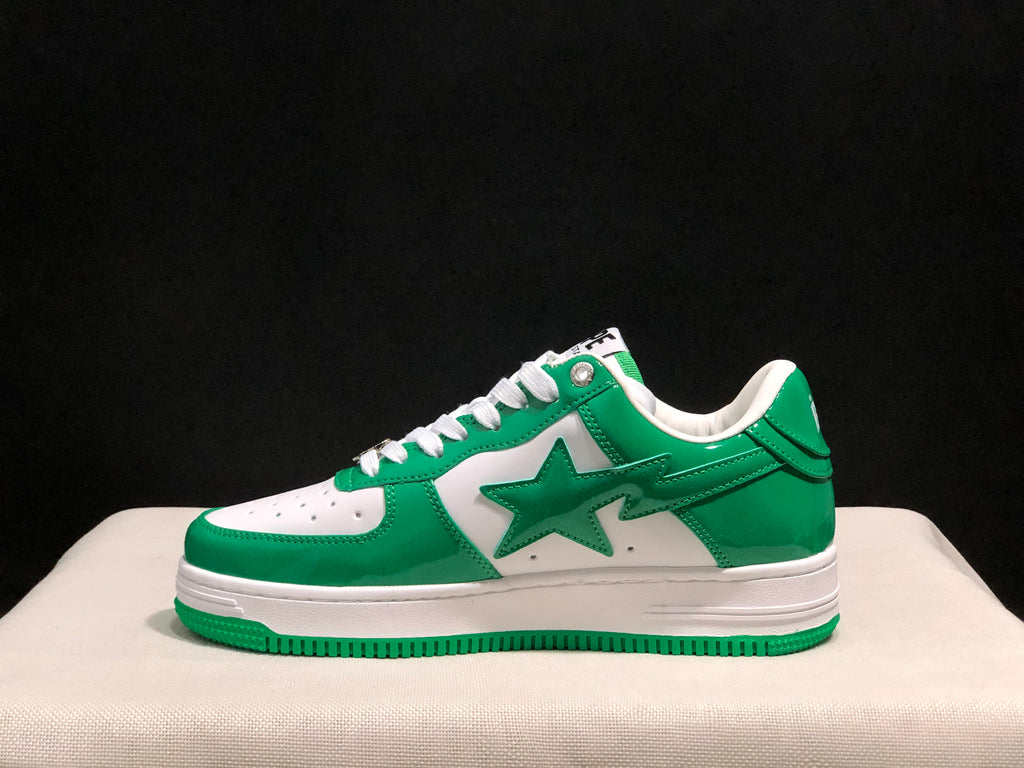 Side profile showing the green star graphic, white side panel, padded collar, and layered white midsole.