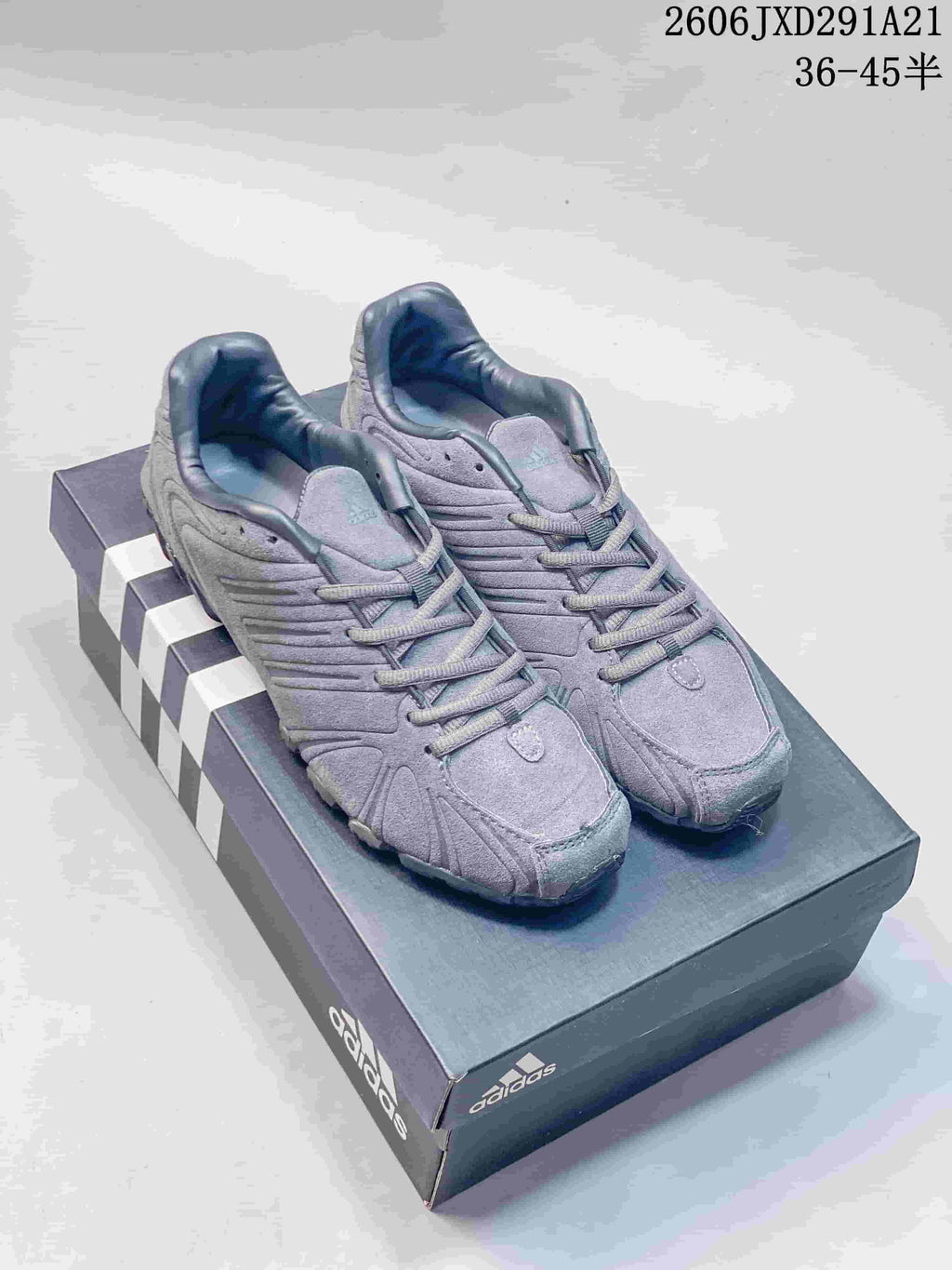 Pair of gray adidas Originals Ghost Sprint sneakers displayed on an adidas shoebox.