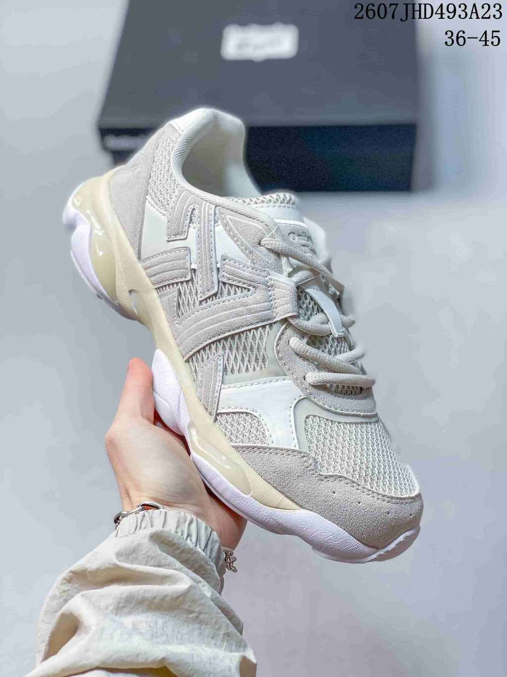 Angled side view of the Onitsuka Tiger TIGRUN sneaker highlighting the textured overlays, mesh panels, and contrast outsole.