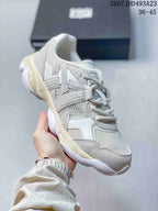 Angled side view of the Onitsuka Tiger TIGRUN sneaker highlighting the textured overlays, mesh panels, and contrast outsole.