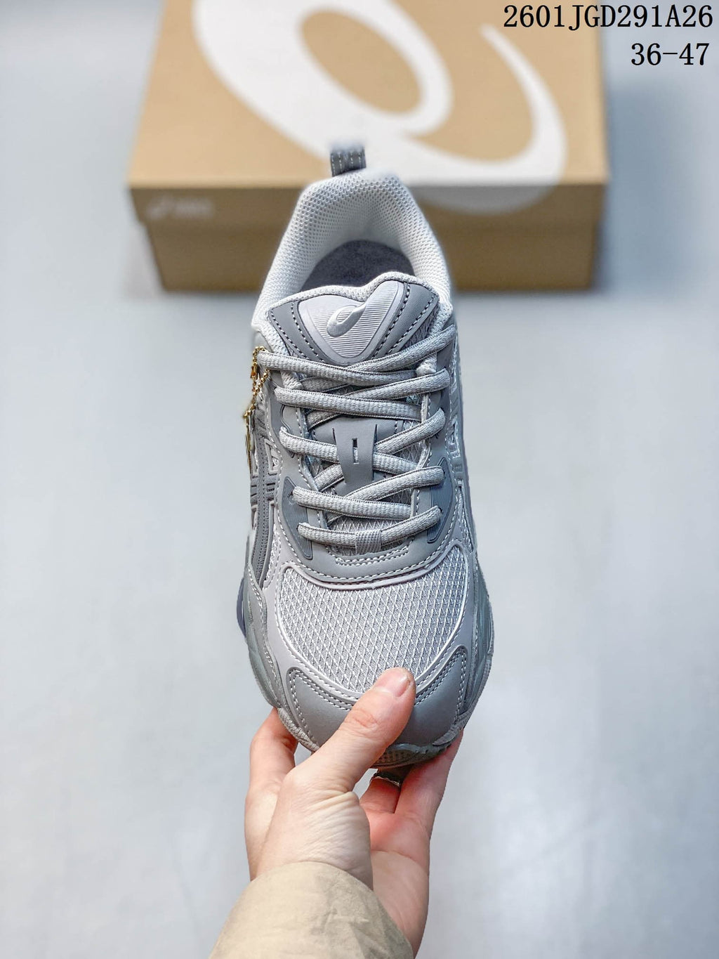 Top view of the gray lace-up sneaker showing the mesh toe area, tongue, and padded collar.
