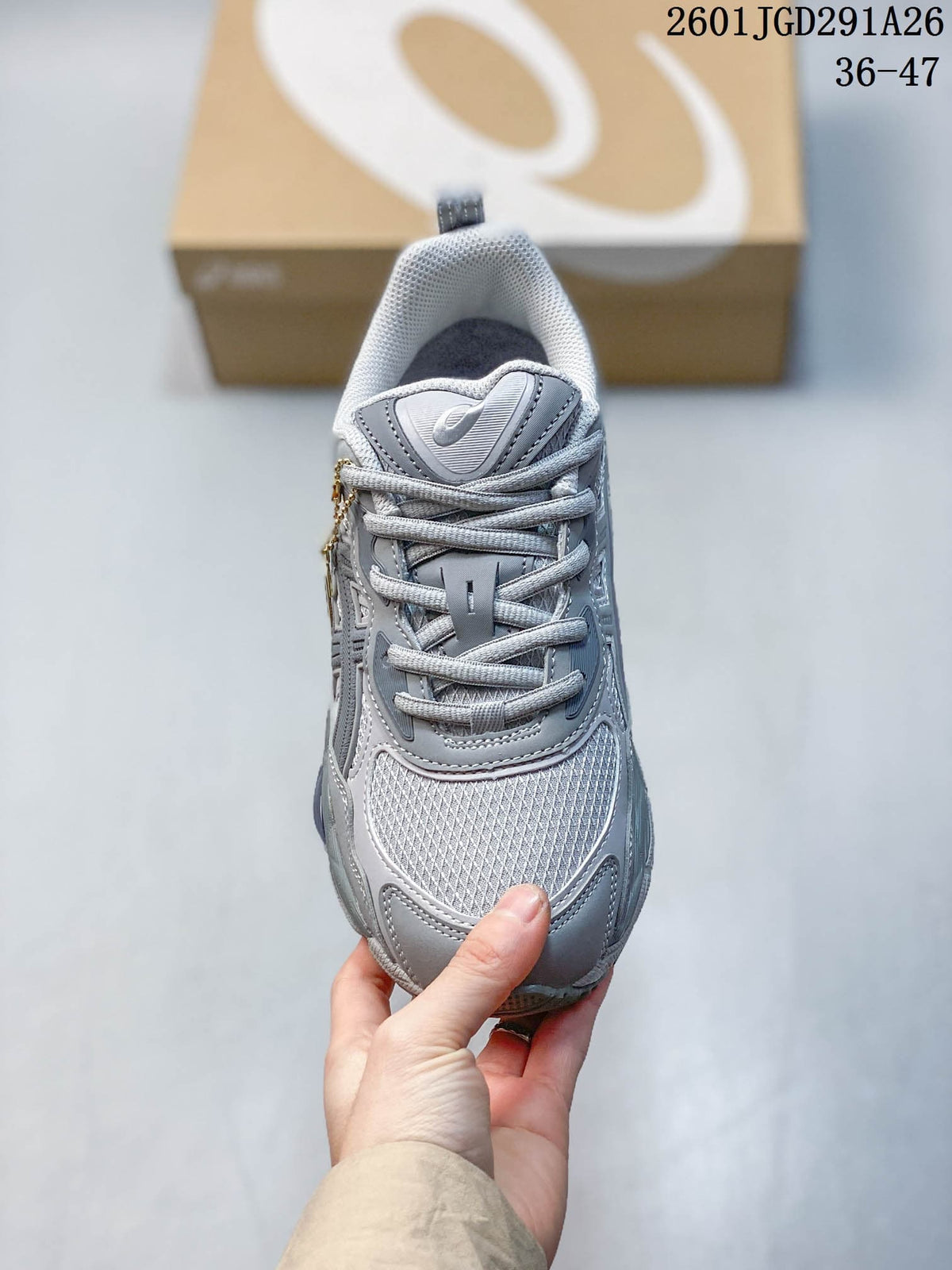 Top view of the gray lace-up sneaker showing the mesh toe area, tongue, and padded collar.