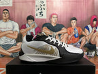 Side view of a white and black Nike basketball shoe with gold-tone Swoosh