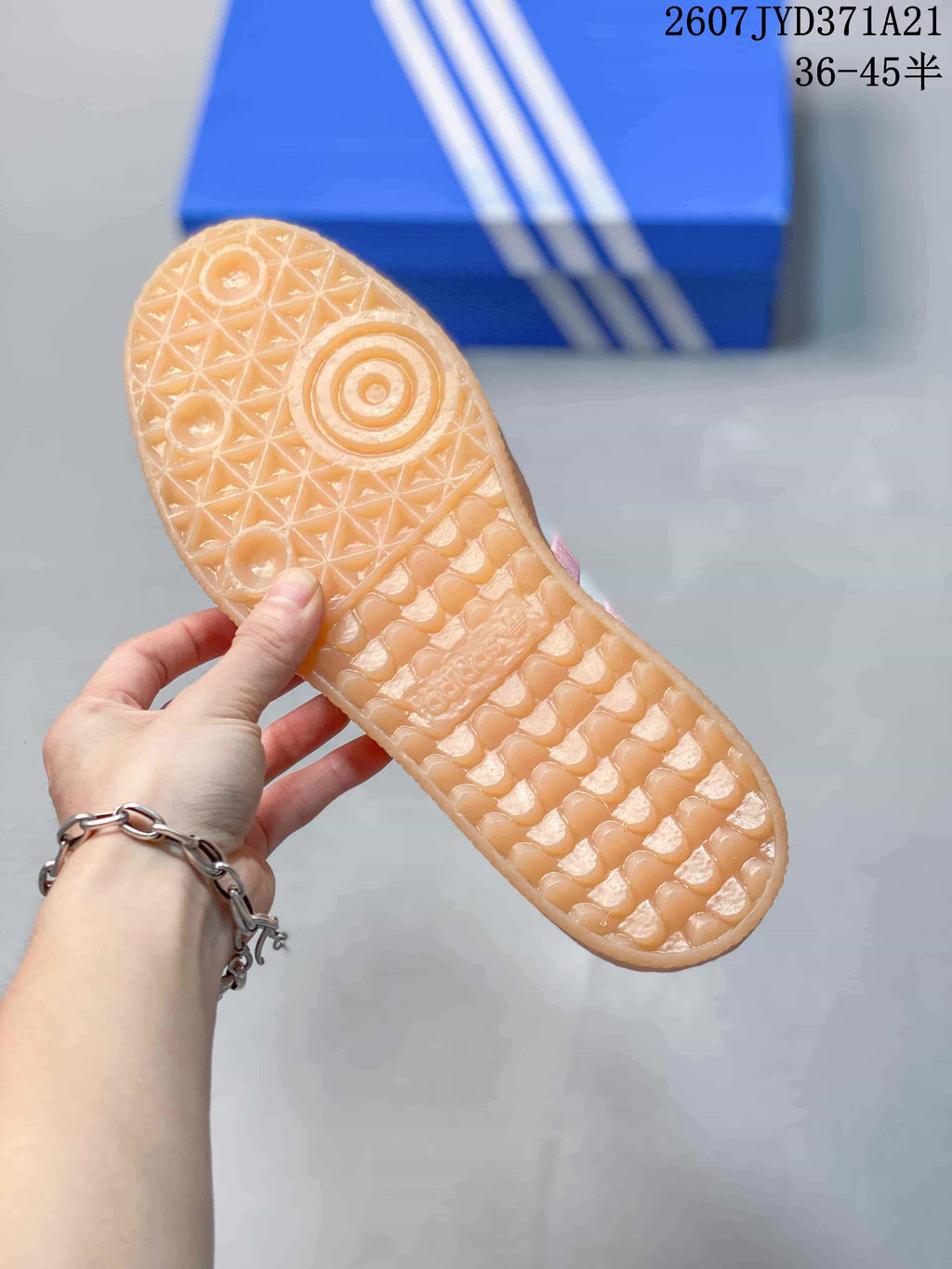 Close-up of the gum-colored outsole showing its geometric textured traction pattern.