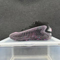 Side view of a black high-top sneaker with a honeycomb-pattern panel and purple and pink accents.