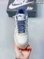 Top view of the sneaker showing the perforated toe box, blue laces, tongue label and padded collar.
