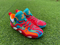 Pair of multicolor Jordan high-top basketball shoes on grass