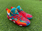 Pair of multicolor Jordan high-top basketball shoes on grass