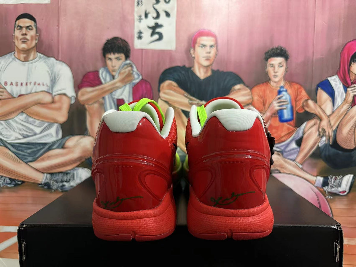 Rear view of red Nike Kobe basketball shoes with white collars and bright green pull tabs.