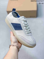 Angled side view of a white ECCO sneaker with blue side branding, perforated panels, laces, and a light-colored outsole.