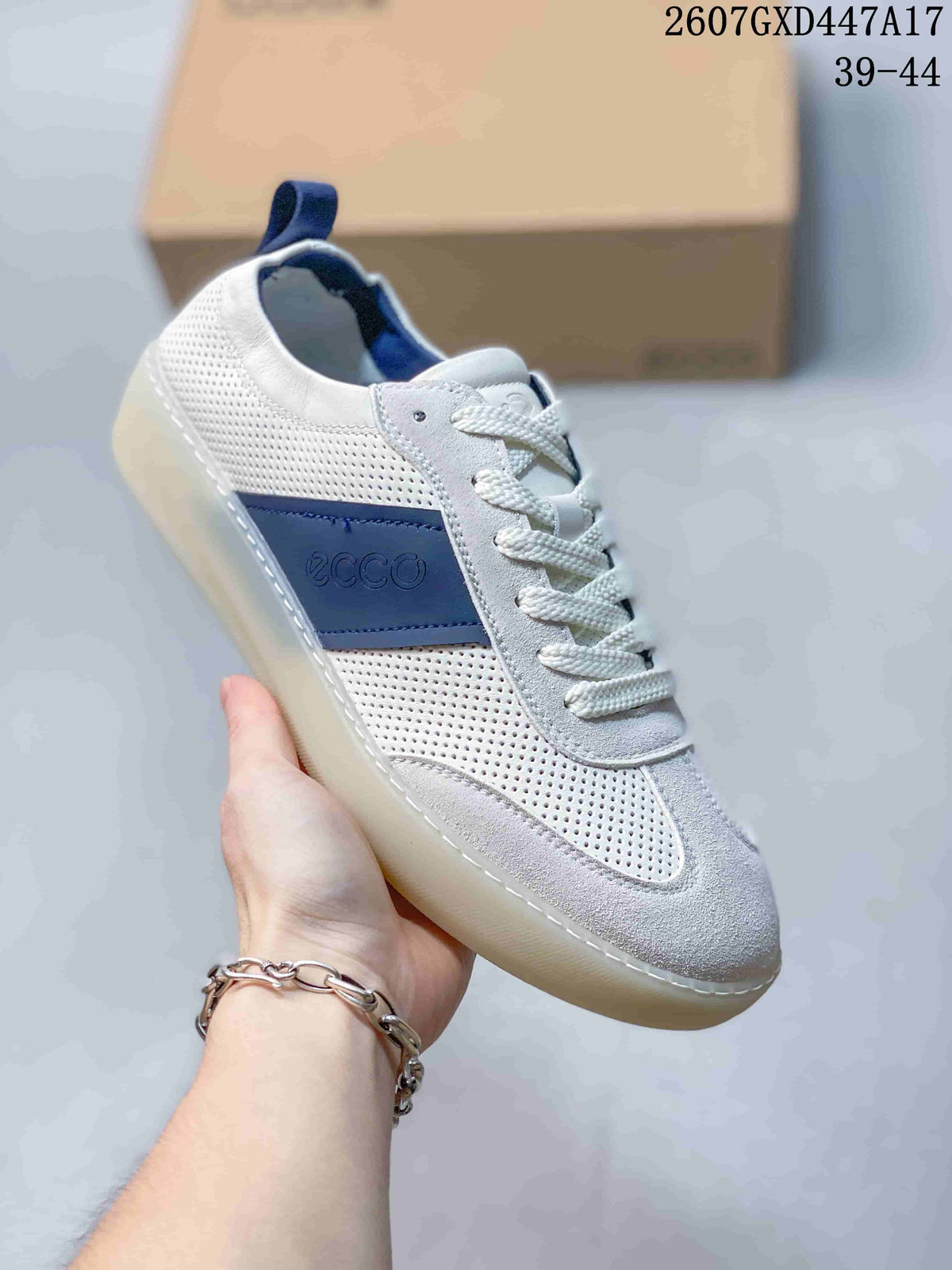 Angled side view of a white ECCO sneaker with blue side branding, perforated panels, laces, and a light-colored outsole.