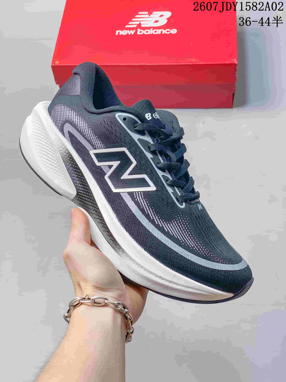 Dark gray New Balance running shoe with a light gray accent and thick white sole.