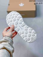 Close view of the white patterned outsole and its raised tread design