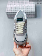 Front view of the sneaker showing the mesh-look toe area, cream laces and Premiata tongue label.