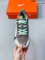 Top view of the sneaker showing the patterned gray upper, mint laces and contrasting Swoosh.