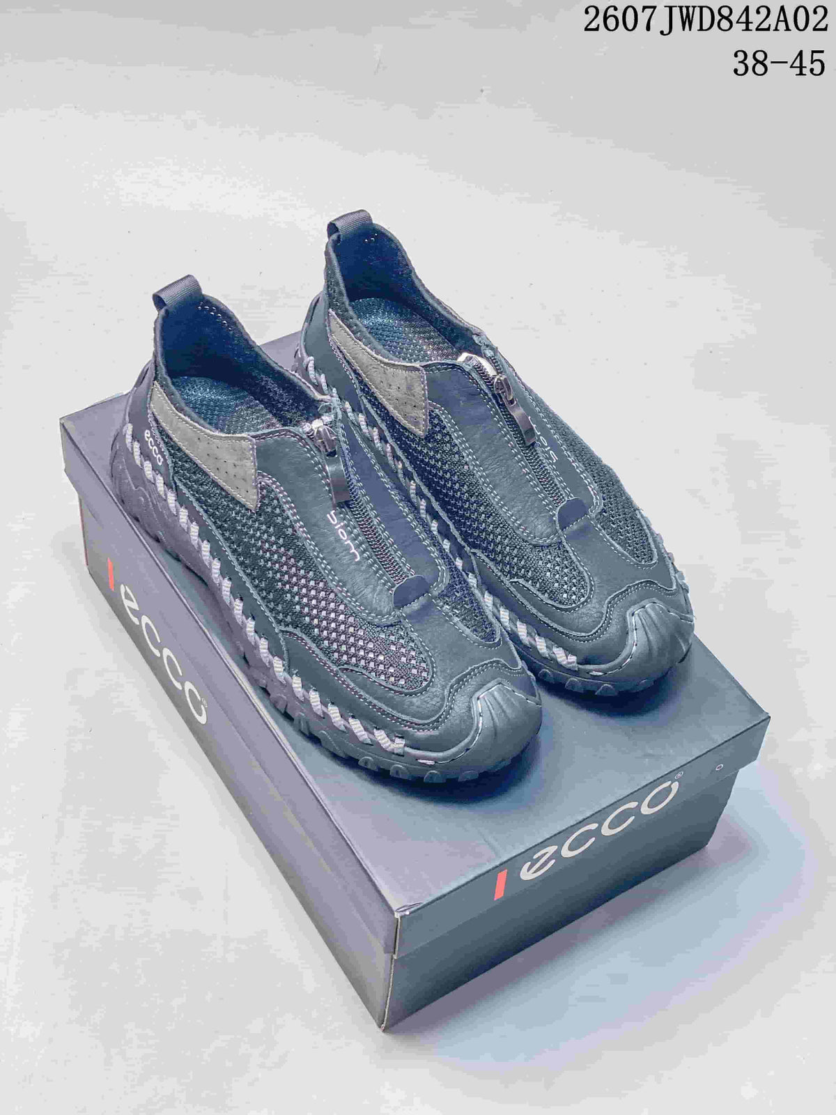 Pair of charcoal gray ECCO zip-front mesh-look casual shoes on a branded box.