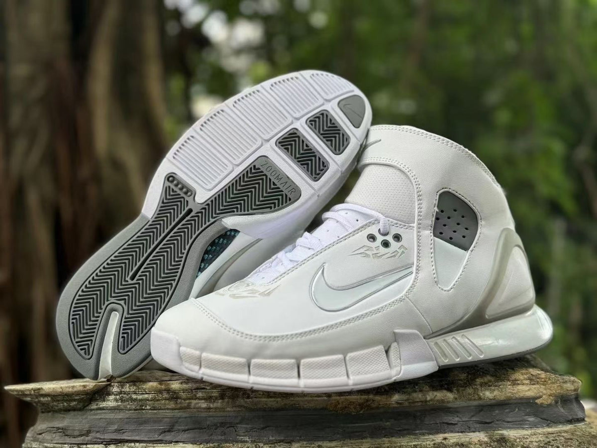 White sneaker pair with the outsole visible, including Zoom Air marking