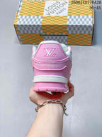 Rear view of a pink and white low-top sneaker