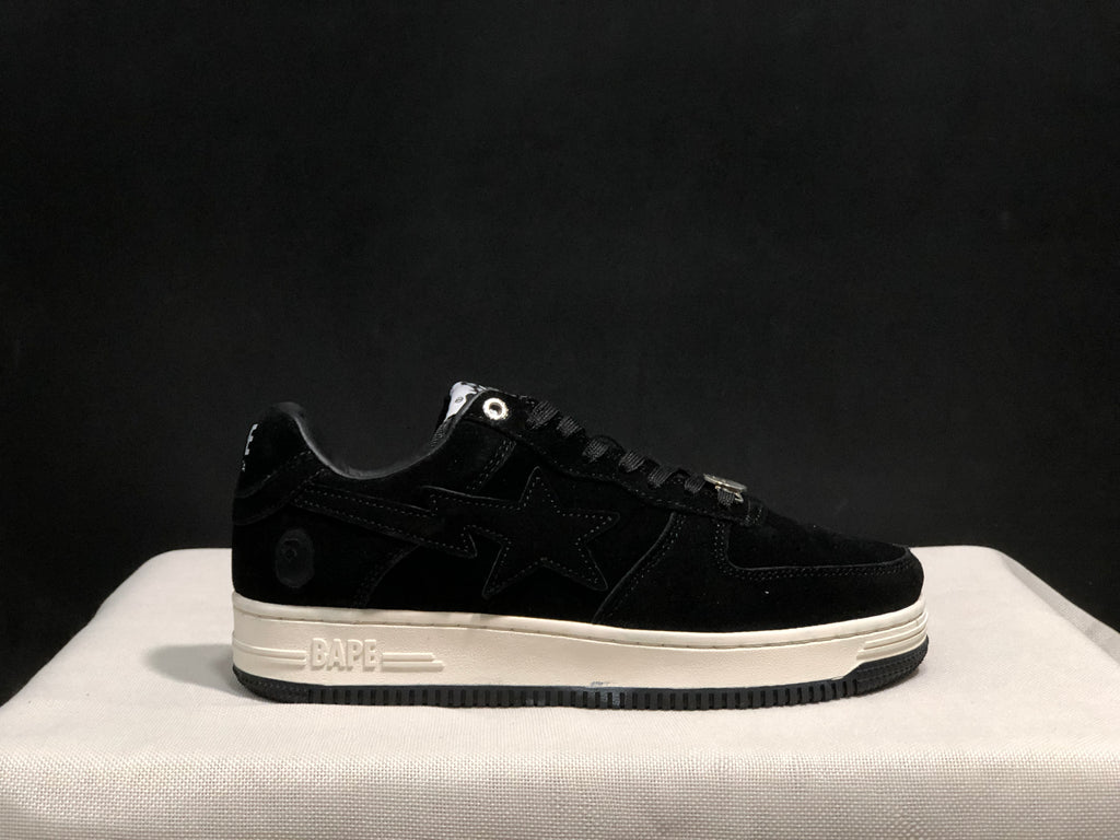 Side view of the black sneaker showing the tonal star panel, heel emblem and embossed BAPE midsole detail.