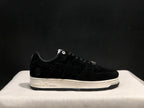 Side view of the black sneaker showing the tonal star panel, heel emblem and embossed BAPE midsole detail.