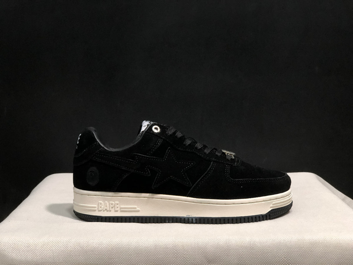 Side view of the black sneaker showing the tonal star panel, heel emblem and embossed BAPE midsole detail.