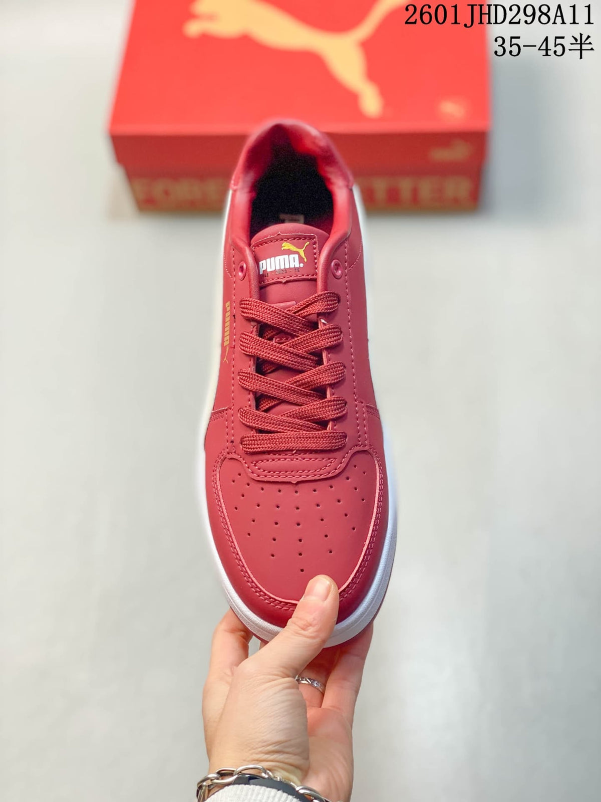 Top view showing the red lace-up upper, padded collar, and perforated toe panel.
