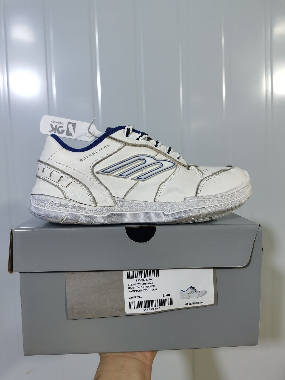 White and blue Balenciaga Hampton sneaker displayed on its box; the box label shows an EU 40 sample and white/blue colorway.