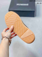Underside of a gum-colored sneaker sole showing a repeating wavy tread pattern.