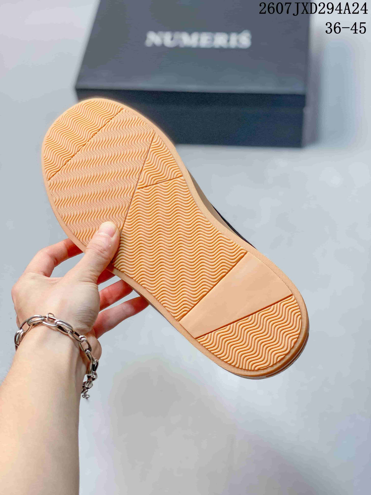 Underside of a gum-colored sneaker sole showing a repeating wavy tread pattern.