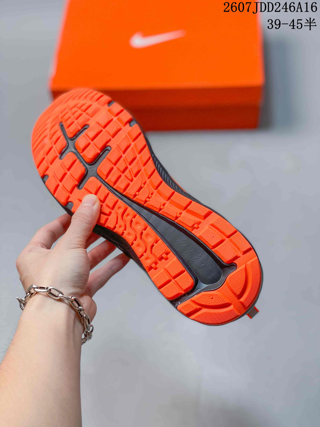 Close view of the orange outsole showing its textured traction pattern and black central sections.