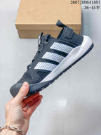 Side profile of the dark gray sneaker with white side details and textured outsole