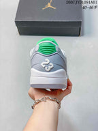 Rear view of the grey sneaker showing green heel detail and white midsole