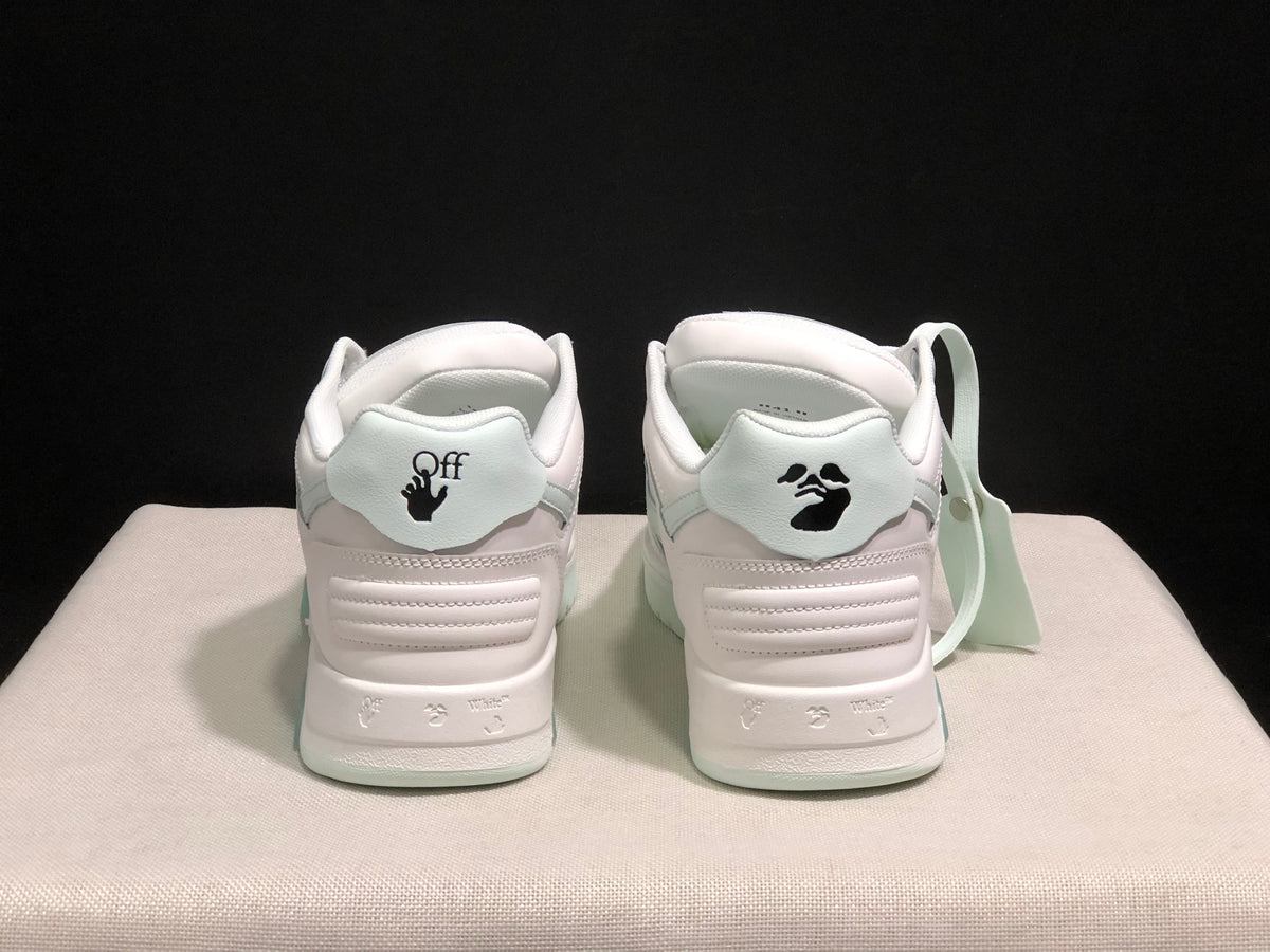 Rear view showing padded heel panels, branding graphics and pale mint outsole accents.