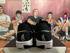 Rear view of black Nike basketball shoes with white midsoles and heel accents
