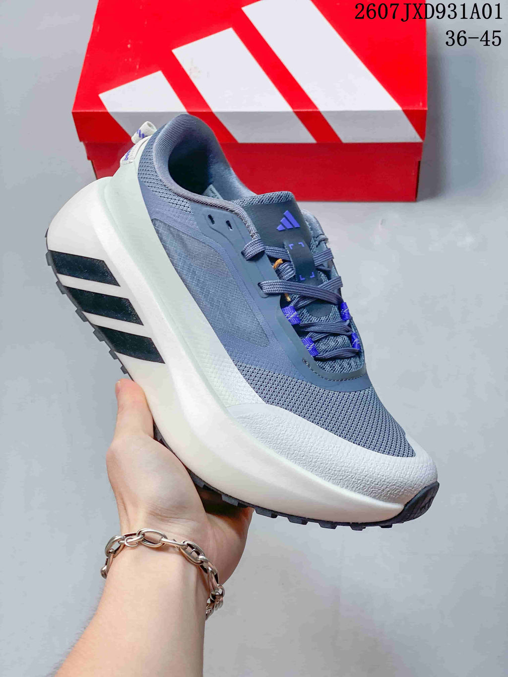 Angled side view of a gray adidas Hyperboost ATR sneaker with purple accents